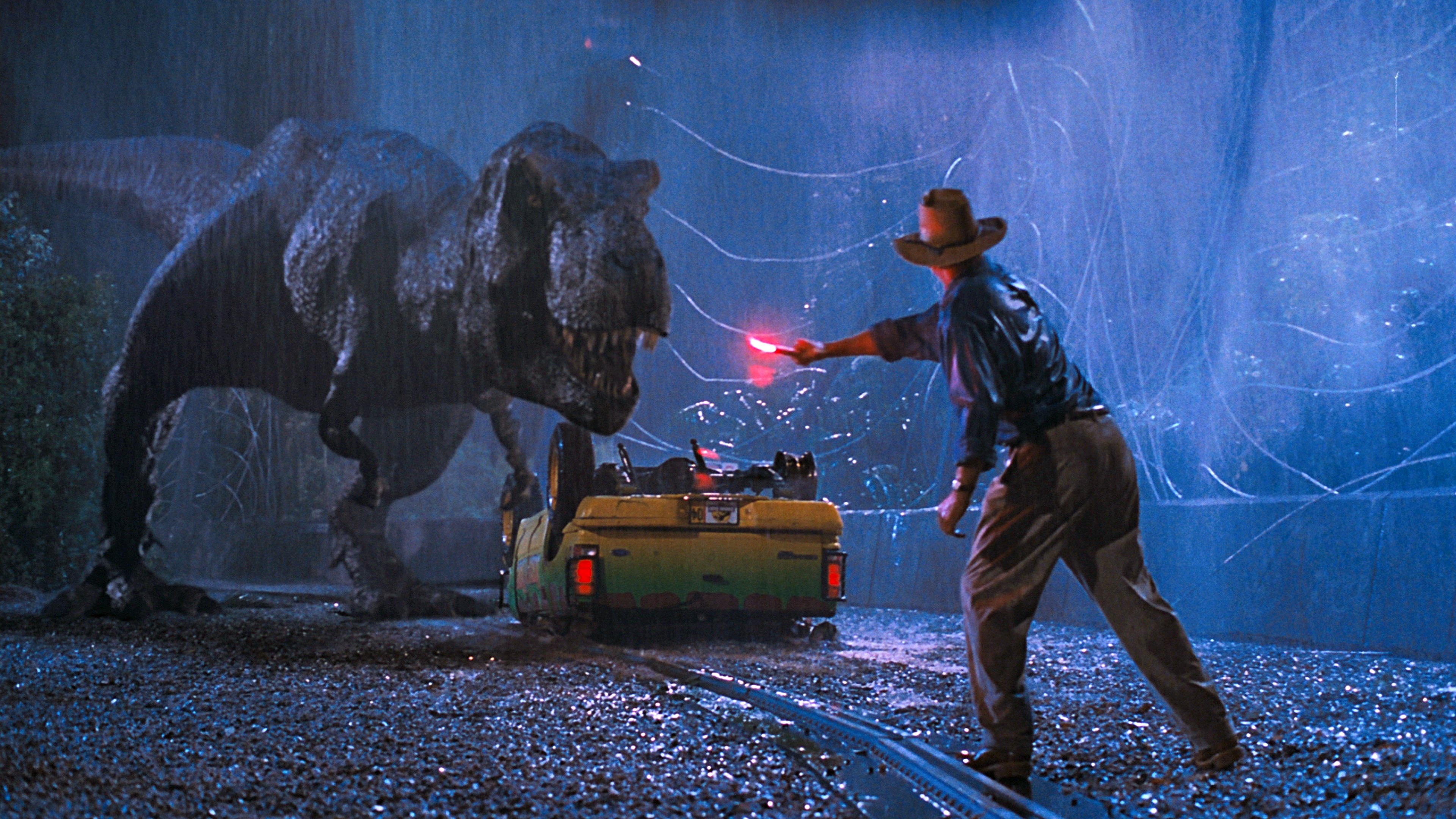 O T-Rex ataca o carro na chuva: a primeira reviravolta irreversível do filme, o ponto onde o Ato 1 fecha e o Ato 2 começa